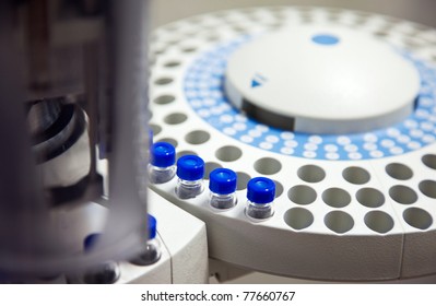Close-up of chromatograph with glass sample bottles. Corona virus vaccine, covid-19.