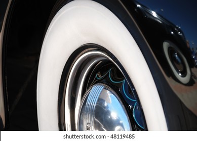 Closeup Of The Chrome Rims With Whitewall Tire