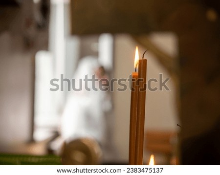 Close-up church candles burn with bright fire in the temple