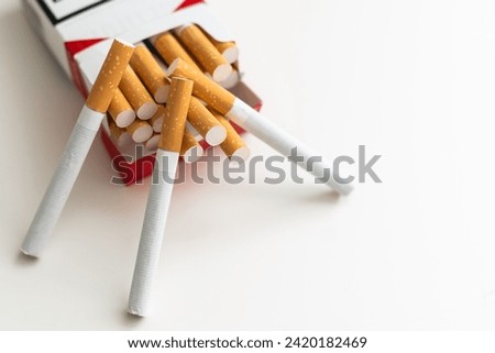 Close-up of cigarette box with filter cigarettes on white background