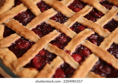 Close-up Of A Classic American Cherry Pie With Crispy Sweet Pastry Lattice. Homemade Festive Cherry Cake With A Flaky Crust. Thanksgiving Concept. Bakery Products