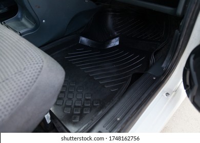 Close-up Of A Clean Black Rubber Auto Mat Under A Passenger Seat In An Old Russian Car After Dry Cleaning.