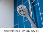 Closeup Clean New Chrome Shiny Dry Shower Head In Bathroom Blue Wall Background