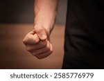 Close-up of a clenched fist, symbolizing aggression, anger, and violence. A powerful stock photo for topics on conflict, emotions, self-defense, and social issues.