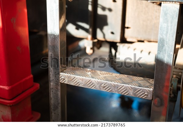 Close-up\
at the climbing step ladder of a trailer truck or crane machine.\
Industrial and transportation part object\
photo.