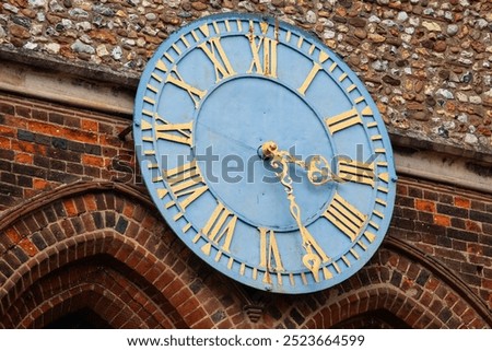 Close-up of the clock located on the tower of the historic St. Marys Church in the town of Hitchin in Hertfordshire, UK.