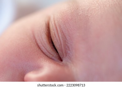 Closeup Of The Closed Eyes Of A Newborn Baby Sleeping In His Crib