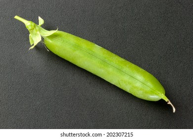 Close-up Of A Closed Fresh Pea Pod.