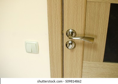 Closeup Of Closed Office Door With The Light Buttons Next To It