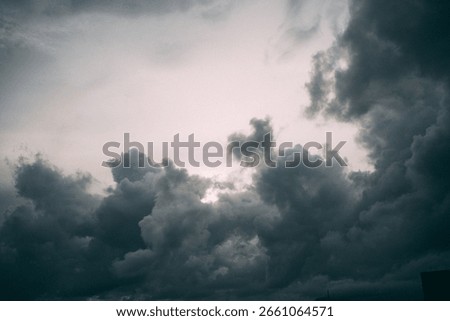 A closeup of cloudy and gloomy clouds surrounding the pink sky