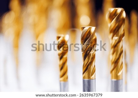 Close-up of cnc machine drill bits with golden coating for precision engineering.