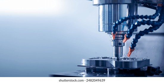 Closeup CNC milling machine during operation. Produced cutting metal parts, banner background of industry heavy factory. - Powered by Shutterstock