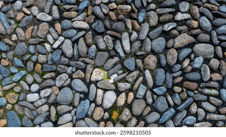 Close-up of a cobblestone pavement with irregularly shaped stones, showcasing natural textures and earthy tones. The aged surface highlights the beauty of traditional stone pathways. - Powered by Shutterstock - Get 15% off with code: PIKWIZARD15
