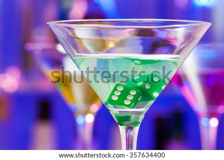 Close-up of cocktail glass with dice inside