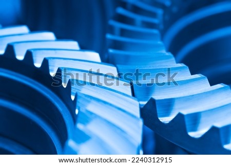Close-up of cog wheels in an engine or machine in blue color