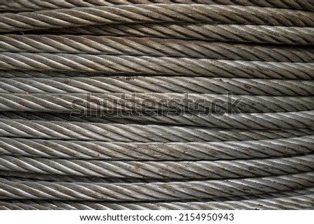 Close-up of Coil large Wire rope sling or Cable sling drum reels stocked in store. Steel wire cable or rope for heavy industrial use, Wire rope texture, Selective Focus.