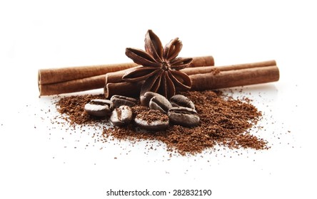 Closeup collected coffee beans with coffee powder with anise and cinnamon on white background - Shutterstock ID 282832190