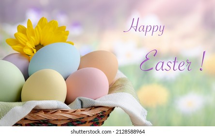 Closeup of colored easter eggs in a basket with colorful springtime background and Happy Easter text