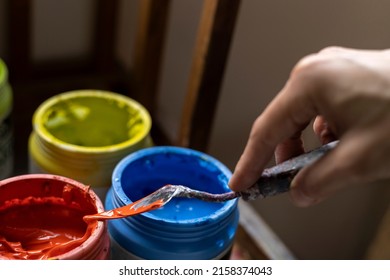 Close-up Of Colorful Acrylic Paint Pots And Palette Knife Used For Painting In Art Studio. Space For Copying. Concept Of Artist And Hobby