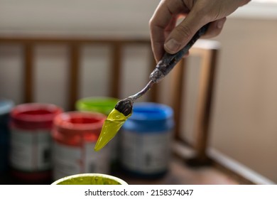 Close-up Of Colorful Acrylic Paint Pots And Palette Knife Used For Painting In Art Studio. Space For Copying. Concept Of Artist And Hobby