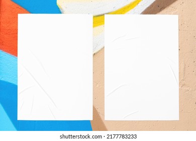 Closeup Of Colorful Blue Red Beige Painted Urban Wall Texture With Two Wrinkled Glued Poster Templates. Modern Mockup For Design Presentation. Creative Urban City Background. 