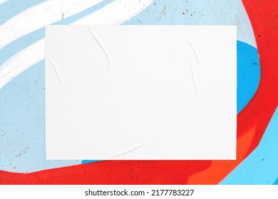 Closeup Of Colorful Blue Red White Painted Urban Wall Texture With Wrinkled Glued Poster Template. Modern Mockup For Design Presentation. Creative Urban City Background. 