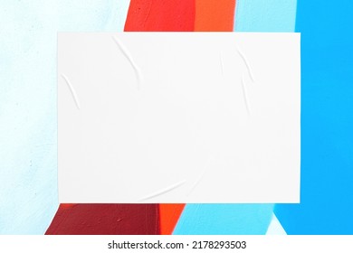 Closeup of colorful blue red white painted urban wall texture with wrinkled glued poster template. Modern mockup for design presentation. Creative urban city background.  - Shutterstock ID 2178293503