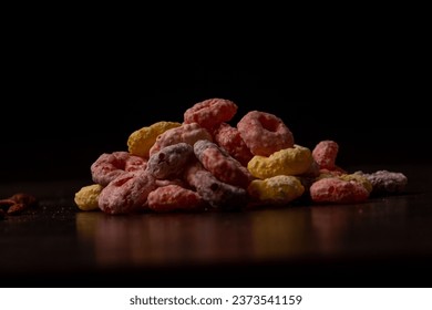 A closeup of colorful breakfast cereal on a wooden surface - Powered by Shutterstock