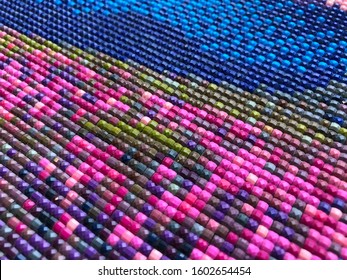 Close-up, colorful diamond embroidery bright. Hobbies and entertainment. The texture of diamond embroidery. Application in shops for hobbies and other leisure products.