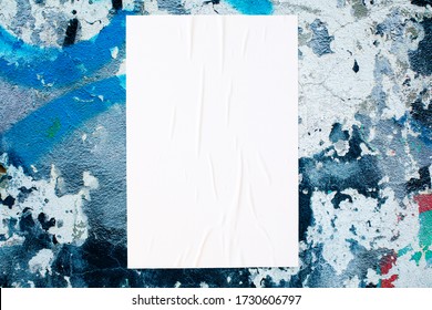 Closeup Of Colorful Messy Painted Urban Wall Texture With Wrinkled Glued Poster Template . Modern Mockup For Design Presentation. Creative Urban City Background. 