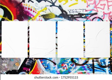 Closeup Of Colorful Messy Painted Urban Wall Texture With Four Wrinkled Glued Poster Templates. Modern Mockup For Design Presentation With Clipping Path. Creative Urban City Background. 