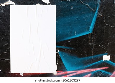 Closeup of colorful messy painted urban wall texture with wrinkled glued poster template . Modern mockup for design presentation. Creative urban city background. 