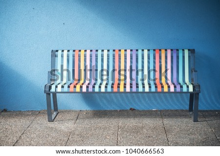closeup of colorful metallic bench in the street 