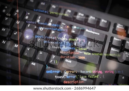 Close-up of colorful programming code overlay on black keyboard, representing modern software development, coding, and digital technology for web development, IT, or cybersecurity concepts.