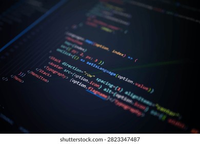 Close-up of colorful programming source code on a computer screen with shallow depth of field, representing software development, web application coding, user interface engineering, digital technology and innovation.