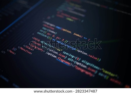 Close-up of colorful programming source code on a computer screen with shallow depth of field, representing software development, web application coding, user interface engineering, digital technology and innovation.