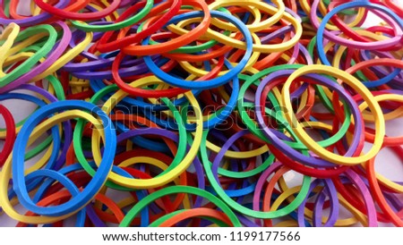 Yellow Rubber Bands Close Up With Hand Isolated On White