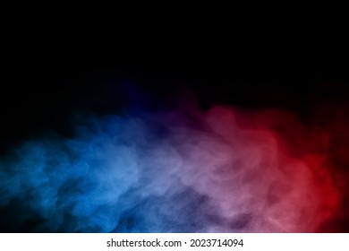Close-up of colorful smoke with spray from a humidifier. Isolated on black background