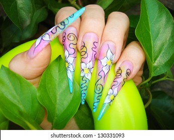 Closeup Of Colorful Stiletto Nails With Floral Free Hand Drawn Pattern