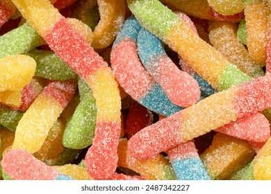 a close-up of colorful, sugar-coated gummy worms - Powered by Shutterstock