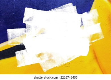 Closeup of colorful yellow and black urban wall texture with white white paint stroke. Modern pattern for design. Creative urban city background. Grunge messy street style background with copy space - Shutterstock ID 2216746453