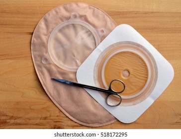 Closeup of colostomy supplies - including scissors, a closed end colostomy pouch and a wafer