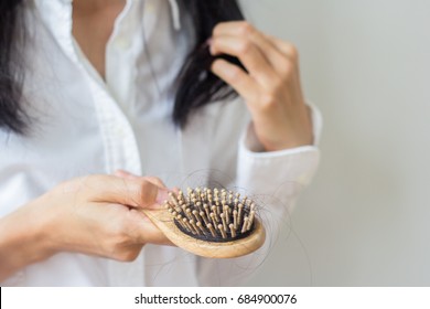 Closeup of comb brush with long loss hair with copy space-Healthcare concept.Selective focus.