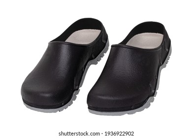Closeup of a comfortable pair of black garden or work clogs isolated on a white background. The shoes are waterproof, easy-care and dirt-repellent and ideal for gardening. Macro.