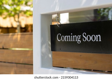 Closeup of a "Coming Soon" real estate sign outside a residential single-family house. Housing market inventory concept. - Shutterstock ID 2159304113