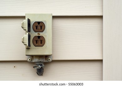 Closeup Of A Common Outdoor Electric Socket On A Wall.