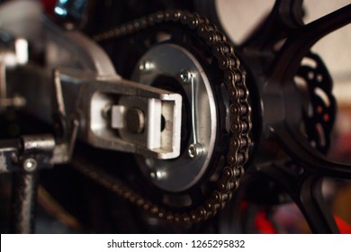 Close-up Of A Competition Motorcycle Chain In Natural Light And Unfocussed Background.