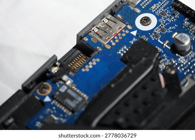 Close-up of a complex electronic circuit board with intricate pathways and components, showing a detailed view of technology and engineering precision.