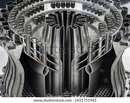 Close-up of a complex metal structure produced through 3D printing, illustrating fine details and precision in the additive manufacturing process, emphasizing innovation and technology.