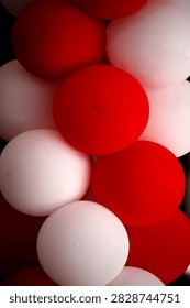 A close-up composition of red and white balloons stacked together creates a striking, festive arrangement with smooth, rounded shapes and contrasting colors. This design captures the festive atmosphere of the Republic of Indonesia’s Independence Day celebrations.